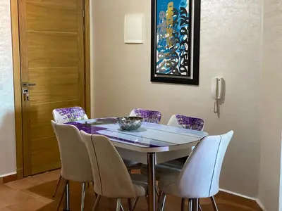 a dining room table with chairs and a bowl on it at studio, à proximité de la gare in Marrakech