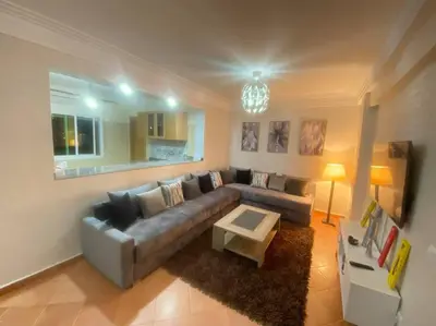 a living room with a couch and a coffee table at studio, à proximité de la gare in Marrakech