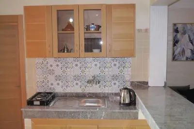 a kitchen with a stove and a counter top at studio, à proximité de la gare in Marrakech