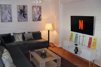 a living room with a couch and a table at studio, à proximité de la gare in Marrakech