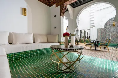 a living room with a couch and a table at The Grand Riad and Spa in Marrakech