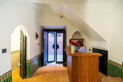 a woman is sitting at a counter in a room at The Grand Riad and Spa in Marrakech