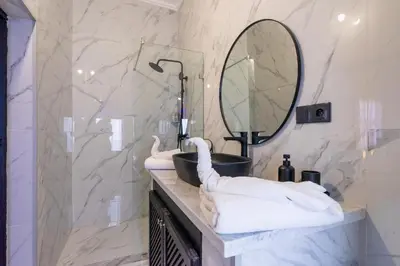 a bathroom with a sink and a mirror at The Grand Riad and Spa in Marrakech