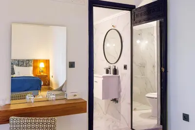 a bathroom with a toilet and a sink and a mirror at The Grand Riad and Spa in Marrakech