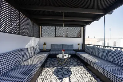 a room with blue benches and a table at The Grand Riad and Spa in Marrakech
