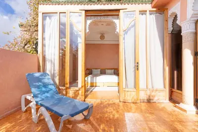 a blue chair sitting on the porch of a house at Villa Korima in Marrakech