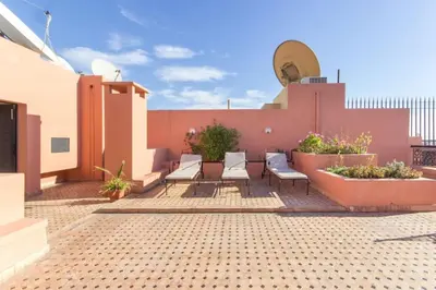 a patio with chairs and plants on a building at Luxury Duplex - Private Jacuzzi - Center Hivernage in Marrakech