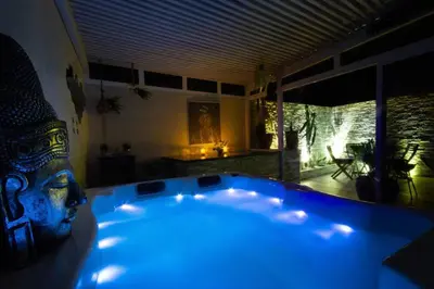a blue bath tub in a room with a statue at Luxury Duplex - Private Jacuzzi - Center Hivernage in Marrakech