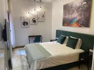 a bedroom with a bed and a painting on the wall at NEW appartement in palmeraie in Marrakech