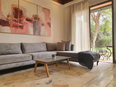 a living room with a couch and a coffee table at NEW appartement in palmeraie in Marrakech