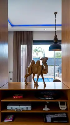 a wooden horse statue sitting on top of a entertainment center at Villa HAW Marrakech in Marrakech