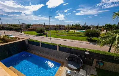 a swimming pool with a toilet and a park at Villa HAW Marrakech in Marrakech