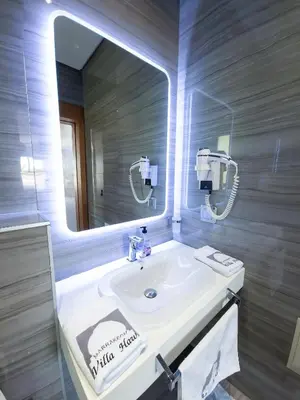 a bathroom with a white sink and a mirror at Villa HAW Marrakech in Marrakech