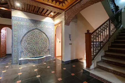 a room with a mosaic tile on the wall and a staircase at Villa Amerchiche in Marrakech