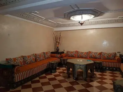 a living room with a couch and a table at Villa Amerchiche in Marrakech