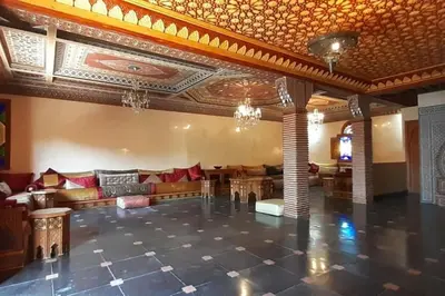 a large room with a couch and tables in it at Villa Amerchiche in Marrakech