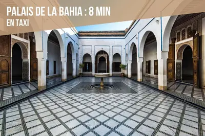 a courtyard of a mosque with a fountain in the middle at L'appart by Louhou Collection in Marrakech