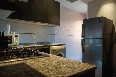 a kitchen with a refrigerator and a counter top at L'appart by Louhou Collection in Marrakech