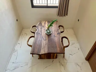 a wooden table with a plant on top of it at Al Badiya Marrakech in Marrakech