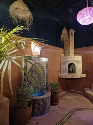 a room with potted plants and a pizza oven at Riad Tesnime in Marrakech