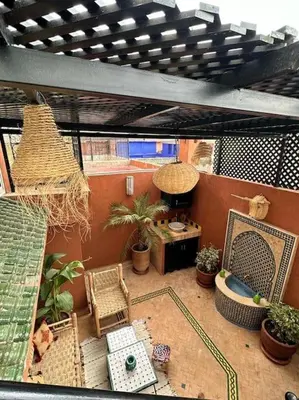 a view of a balcony with chairs and plants at Riad Tesnime in Marrakech