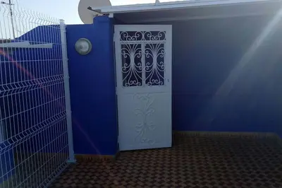 a blue room with a door with a gate at Appartement centre de Marrakech in Marrakech