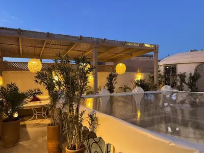 a balcony of a hotel with plants and lights at Riad Dollar Des Sables & Spa in Marrakech