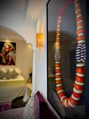 a mirror in a room with a room with a bed at Riad Dollar Des Sables & Spa in Marrakech