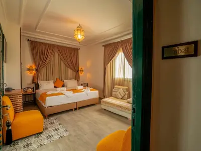 a hotel room with a bed and a window at Riad Dar Sido in Marrakech