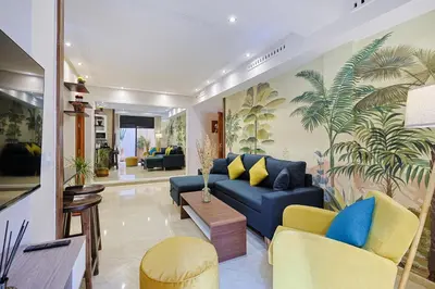 a living room with a blue couch and yellow chairs at Oasis - Appartement Authentique à Gueliz in Marrakech