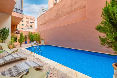 a swimming pool in the middle of a building at Oasis - Appartement Authentique à Gueliz in Marrakech