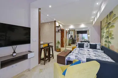 a bedroom with a bed and a tv on a wall at Oasis - Appartement Authentique à Gueliz in Marrakech