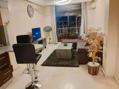 a living room with a couch and a table at Appartement gueliz in Marrakech