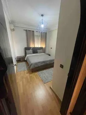 a bedroom with a bed in a room with a window at Appartement gueliz in Marrakech