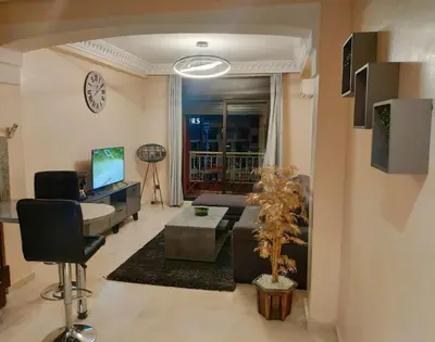 a living room with a couch and a table at Appartement gueliz in Marrakech