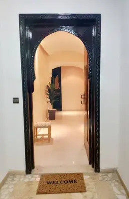a mirror in a hallway with a welcome mat in front of it at Appartement gueliz in Marrakech