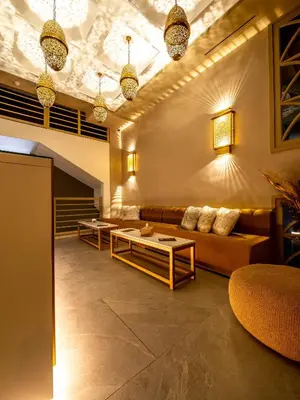 a living room with couches and tables and lights at Fashion Boutique Hotel in Marrakech