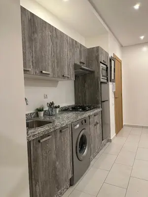 a kitchen with a sink and a washing machine at Cosy studio au centre de Marrakech Netflix in Marrakech