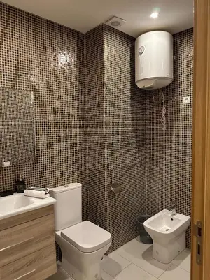 a bathroom with a toilet and a sink at Cosy studio au centre de Marrakech Netflix in Marrakech