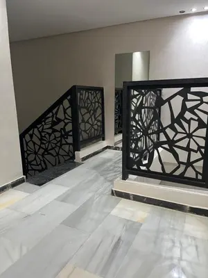 an empty room with a black iron gate at Duplex Centre-ville Guéliz in Marrakech