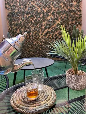a tea kettle and a glass on a table at Duplex Centre-ville Guéliz in Marrakech