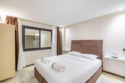 a bedroom with a large bed with towels on it at Duplex Centre-ville Guéliz in Marrakech
