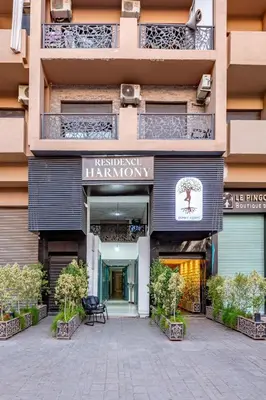 a building with a sign for the entrance to a pharmacy at Duplex Centre-ville Guéliz in Marrakech