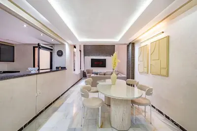 a dining room with a table and chairs at Duplex Centre-ville Guéliz in Marrakech