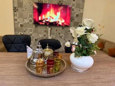 a table with a vase of flowers and a tray with candles at Argan Golf Villa 4-bed Marrakech in Marrakech