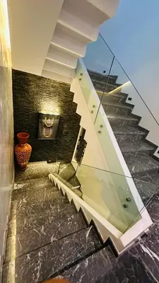 a glass staircase in a building with a vase at Argan Golf Villa 4-bed Marrakech in Marrakech