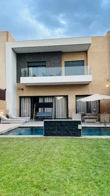 a house with a swimming pool in front of it at Argan Golf Villa 4-bed Marrakech in Marrakech