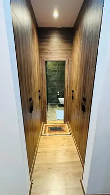 a hallway leading to a bathroom with wooden walls at Argan Golf Villa 4-bed Marrakech in Marrakech