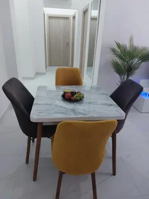 a table with chairs and a bowl of fruit on it at Centre Marrakech, Chic et Calme in Marrakech
