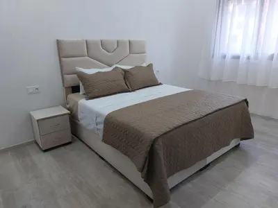 a bedroom with a large bed with a large headboard at Centre Marrakech, Chic et Calme in Marrakech